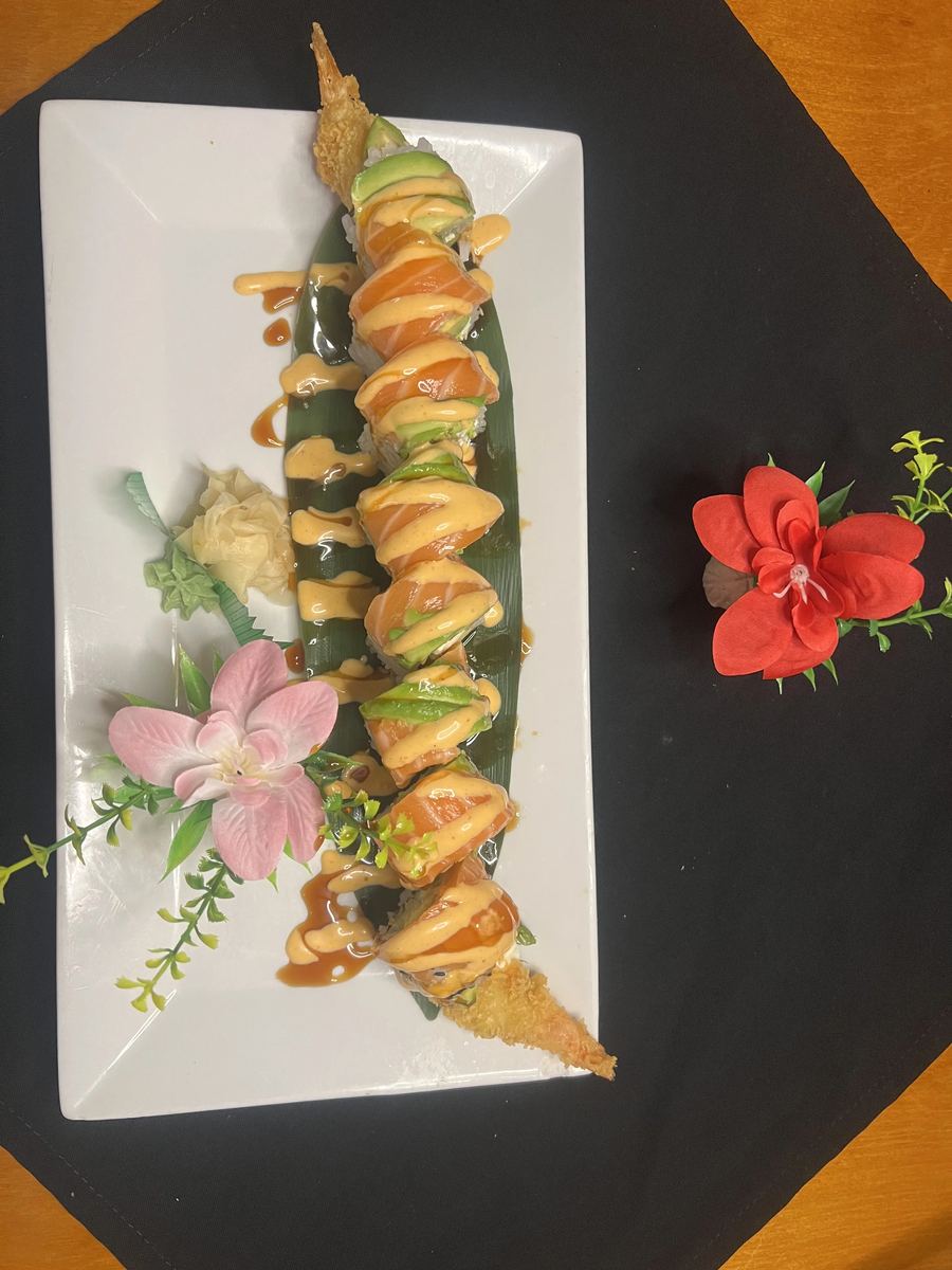 Assorted sashimi artfully plated with bamboo leaf and garnish