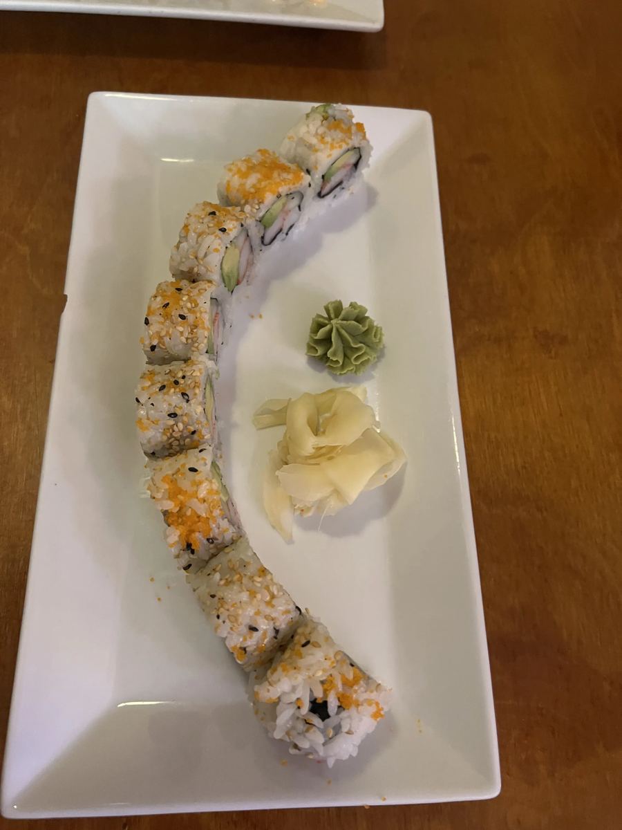 Rainbow roll topped with salmon, tuna, and avocado
