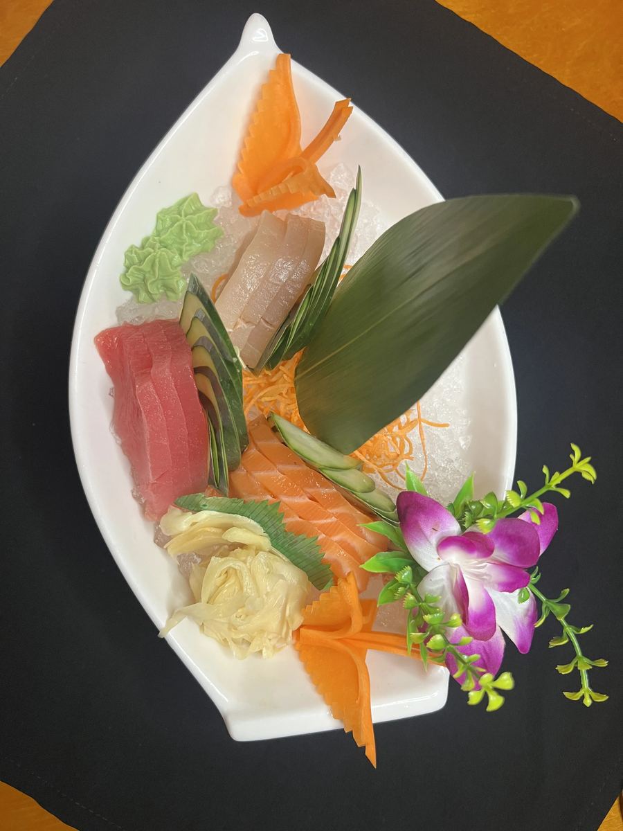 Salmon dragon roll draped in avocado with spicy mayo
