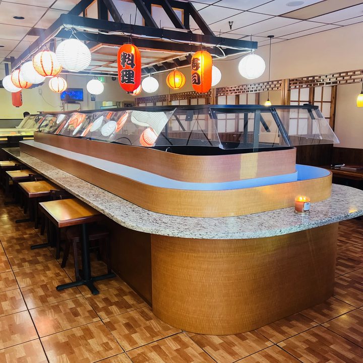 The sushi bar at The King and I in Miami Lakes, with paper lanterns over a curved granite counter